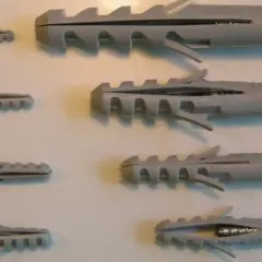 Variedad de tipos de tacos para pared, con tornillos de diferentes tamaños.