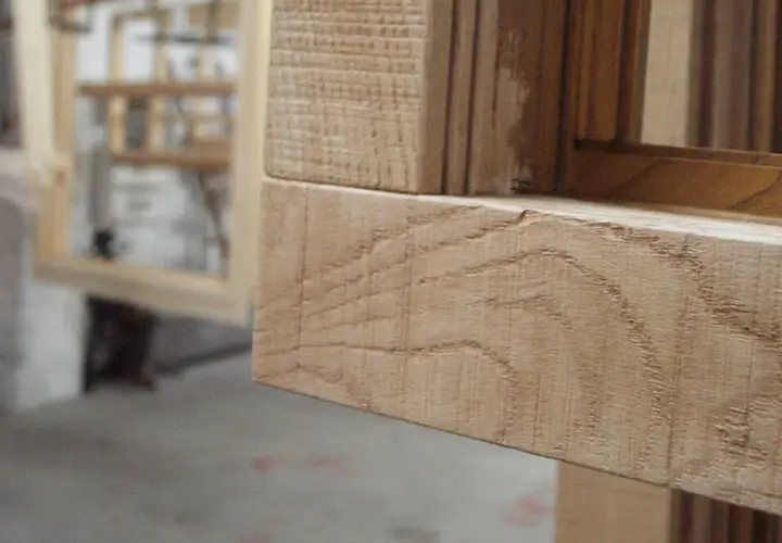 Marco de ventana de madera con vetas visibles y detalle de textura.