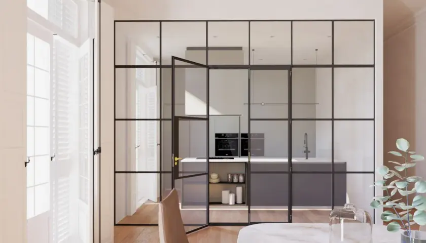 Elegantes tipos de cerramientos interiores de cristal y metal separan la cocina moderna del comedor.