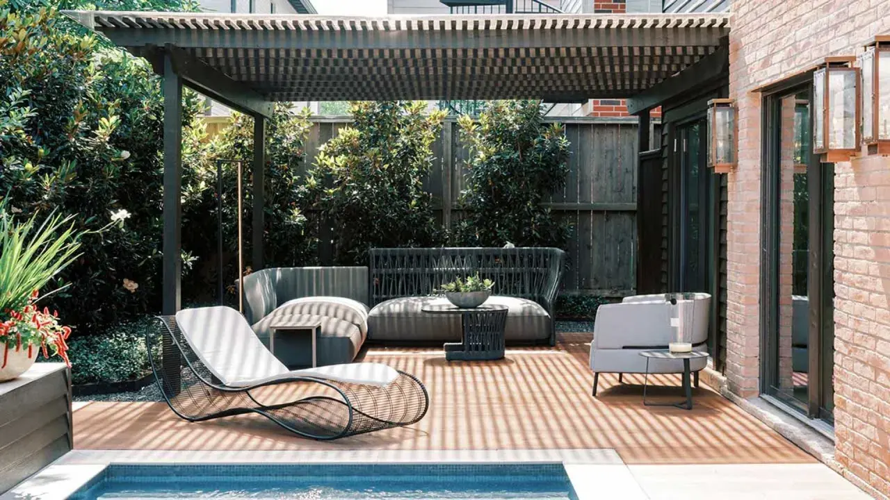 Modernos porches para patios con muebles de exterior, piscina y vegetación exuberante.